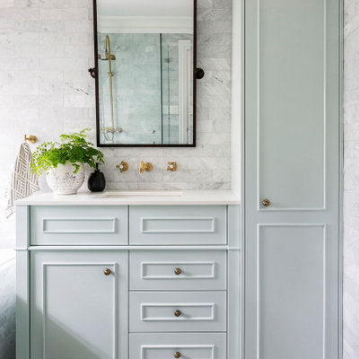 Elegant gray tile and marble tile marble floor drop-in bathtub photo in Sydney with shaker cabinets, green cabinets, an undermount sink, marble countertops and white countertops