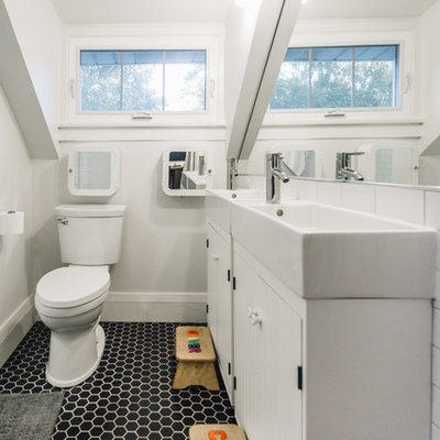 Example of a small trendy kids' black and white tile and porcelain tile porcelain tile alcove shower design in Minneapolis with furniture-like cabinets, white cabinets, a two-piece toilet, gray walls and a wall-mount sink