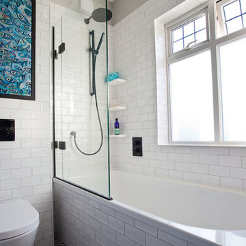 Family bathroom with matt black detailing and patterned tile floor – Hove
