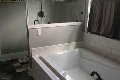Example of a mid-sized farmhouse master white tile and ceramic tile ceramic tile and gray floor bathroom design in Other with gray walls and a hinged shower door