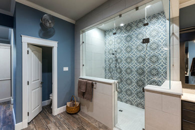 Walk-in shower - farmhouse master black tile and porcelain tile porcelain tile and brown floor walk-in shower idea in Dallas with raised-panel cabinets, dark wood cabinets, a two-piece toilet, blue walls, an undermount sink, quartz countertops, a hinged shower door and white countertops