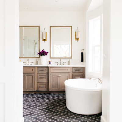 Large farmhouse master porcelain tile and black floor freestanding bathtub photo in San Diego with shaker cabinets, dark wood cabinets, white walls, an undermount sink and quartz countertops