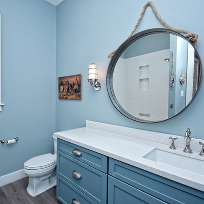 Inspiration for a coastal gray floor bathroom remodel in Austin with shaker cabinets, blue cabinets, blue walls, an undermount sink and white countertops