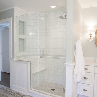 Corner shower - mid-sized country master subway tile and white tile porcelain tile corner shower idea in Chicago with an undermount sink, raised-panel cabinets, white cabinets and green walls
