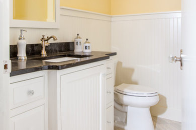 Inspiration for a mid-sized timeless 3/4 gray tile and porcelain tile porcelain tile bathroom remodel in Minneapolis with beaded inset cabinets, white cabinets, a two-piece toilet, yellow walls, an undermount sink and quartz countertops