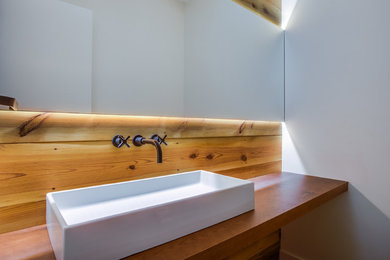 Foto di una stanza da bagno country con ante in legno scuro, lavabo a bacinella e top in legno
