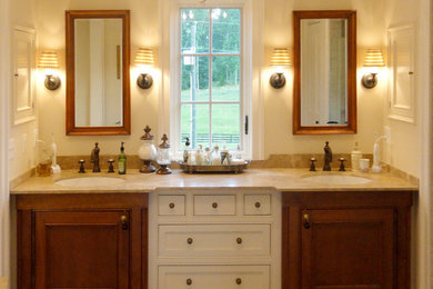 Photo of a medium sized traditional ensuite bathroom in DC Metro with beaded cabinets, medium wood cabinets, an alcove shower, beige walls, ceramic flooring, a submerged sink, granite worktops, beige floors and a hinged door.