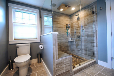 Mid-sized master brown tile and porcelain tile porcelain tile and gray floor corner shower photo in New York with beaded inset cabinets, gray cabinets, a two-piece toilet, blue walls, an undermount sink, marble countertops, a hinged shower door and white countertops