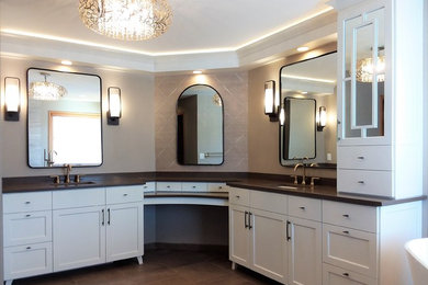 Example of a transitional master beige tile and marble tile porcelain tile and brown floor bathroom design in Minneapolis with recessed-panel cabinets, white cabinets, a one-piece toilet, beige walls, an undermount sink, quartz countertops and brown countertops