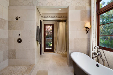 Freestanding bathtub - mediterranean stone tile freestanding bathtub idea in San Francisco