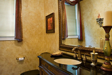 Bathroom - mid-sized traditional ceramic tile bathroom idea in Philadelphia with furniture-like cabinets, dark wood cabinets, a two-piece toilet, yellow walls and an undermount sink