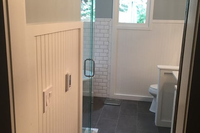 Example of a classic master white tile and subway tile doorless shower design in Atlanta with a one-piece toilet and blue walls