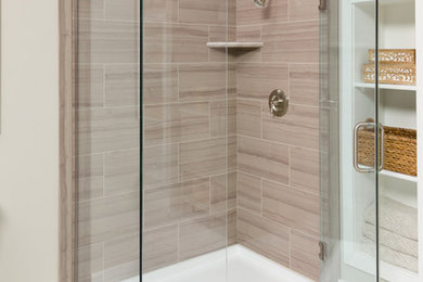 Design ideas for a large traditional ensuite bathroom in Salt Lake City with a corner shower, beige tiles, porcelain tiles, beige walls, ceramic flooring, white floors, a hinged door, open cabinets and white cabinets.