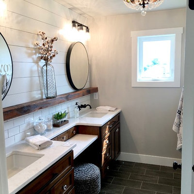 Inspiration for a mid-sized country master ceramic tile and black floor alcove shower remodel in Other with furniture-like cabinets, dark wood cabinets, a one-piece toilet, gray walls, a drop-in sink, marble countertops and a hinged shower door