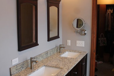 Mid-sized transitional master gray tile and porcelain tile porcelain tile alcove shower photo in Other with shaker cabinets, dark wood cabinets, a two-piece toilet, gray walls, an undermount sink and granite countertops