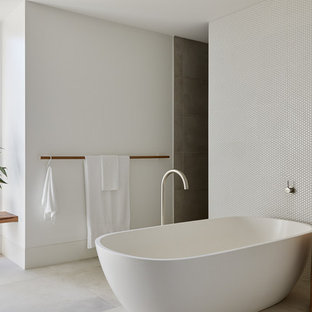 This is an example of a scandinavian master bathroom in Melbourne with a freestanding tub, white tile, mosaic tile, white walls and grey floor.