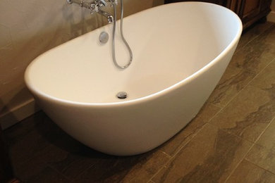 Immagine di una grande stanza da bagno con doccia classica con ante con riquadro incassato, vasca freestanding, lavabo da incasso e top in marmo