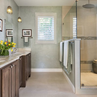Mid-sized transitional master beige tile and porcelain tile porcelain tile corner shower photo in Miami with shaker cabinets, medium tone wood cabinets, green walls, an undermount sink and limestone countertops