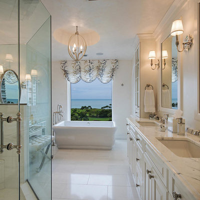 Large elegant bathroom photo in New York with an undermount sink, raised-panel cabinets and white cabinets