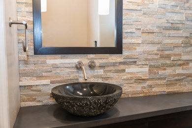 Example of a mid-sized trendy stone tile bathroom design in Denver with a vessel sink, dark wood cabinets and quartz countertops