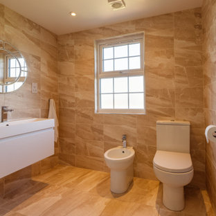This is an example of a medium sized contemporary shower room bathroom in London with flat-panel cabinets, white cabinets, a one-piece toilet, beige tiles, porcelain tiles, porcelain flooring, a trough sink, beige floors and white worktops.