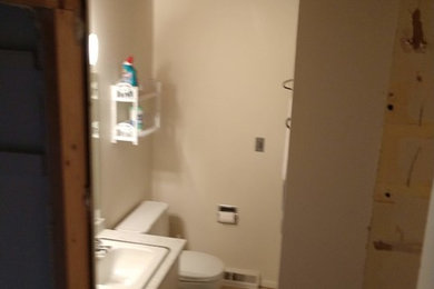 Example of a large trendy master white tile and ceramic tile porcelain tile and gray floor bathroom design in Grand Rapids with flat-panel cabinets, a one-piece toilet, white walls and an integrated sink