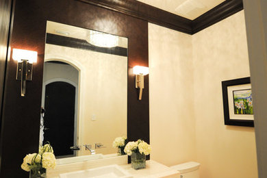 Example of a mid-sized trendy 3/4 ceramic tile and beige floor bathroom design in Miami with flat-panel cabinets, dark wood cabinets, a one-piece toilet, beige walls, a drop-in sink, quartz countertops and white countertops