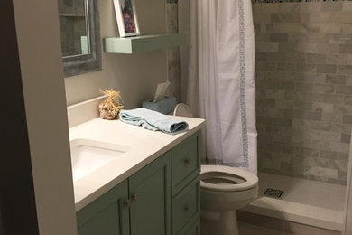 Inspiration for a mid-sized transitional 3/4 gray tile and subway tile porcelain tile alcove shower remodel in Miami with recessed-panel cabinets, green cabinets, a two-piece toilet, beige walls, an undermount sink and quartz countertops