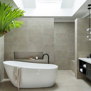 Photo of a mid-sized contemporary master bathroom in Perth with shaker cabinets, a freestanding tub, a double vanity, a built-in vanity, black cabinets, an open shower, gray tile, porcelain tile, porcelain floors, a vessel sink, grey floor, an open shower, white benchtops and a niche.