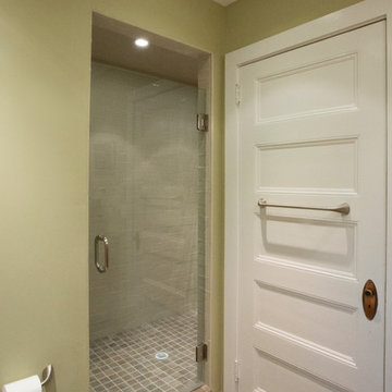 Frame-less shower door opens to custom tiled shower space