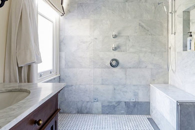 Photo of a medium sized contemporary bathroom in Denver with freestanding cabinets, dark wood cabinets, a built-in shower, a one-piece toilet, grey tiles, marble tiles, beige walls, marble flooring, a submerged sink, marble worktops, multi-coloured floors, an open shower and grey worktops.