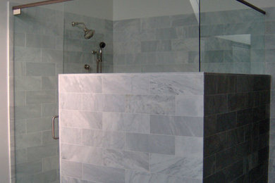 Inspiration for a mid-sized modern gray tile, white tile and marble tile marble floor and gray floor alcove shower remodel in Omaha with multicolored walls and a hinged shower door