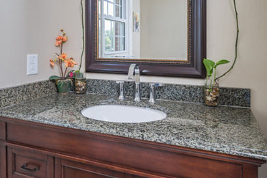 Example of a small classic 3/4 white tile and porcelain tile porcelain tile bathroom design in Other with furniture-like cabinets, dark wood cabinets, beige walls, a drop-in sink and granite countertops