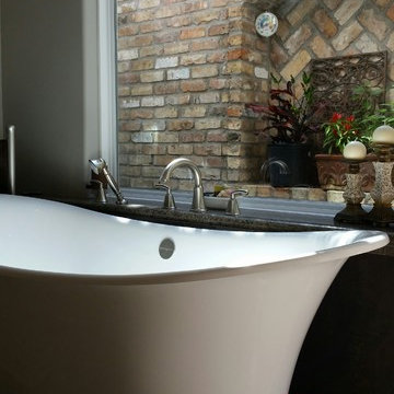 Freestanding Victoria & Albert Toulouse Tub under picture window and brick wall