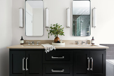 Large transitional master subway tile marble floor and beige floor bathroom photo in Other with shaker cabinets, black cabinets, white walls, quartz countertops, a hinged shower door and beige countertops