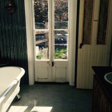 French doors in the bathroom lead outside to outdoor shower
