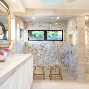 Example of a large french country master gray tile and marble tile limestone floor and gray floor double shower design in Orange County with furniture-like cabinets, gray cabinets, a two-piece toilet, white walls, an undermount sink, limestone countertops, a hinged shower door and gray countertops
