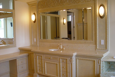 Example of a large trendy master multicolored tile and stone tile marble floor bathroom design in San Diego with furniture-like cabinets, beige cabinets, a two-piece toilet, multicolored walls, marble countertops and an undermount sink