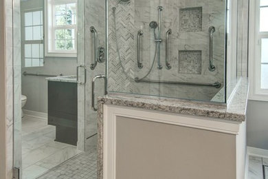 Bathroom - large transitional master multicolored tile and stone slab marble floor bathroom idea in Cleveland with recessed-panel cabinets, dark wood cabinets, gray walls, an undermount sink and granite countertops
