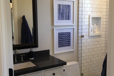 Example of a mid-sized minimalist kids' bathroom design in Orange County with furniture-like cabinets, white cabinets and quartzite countertops