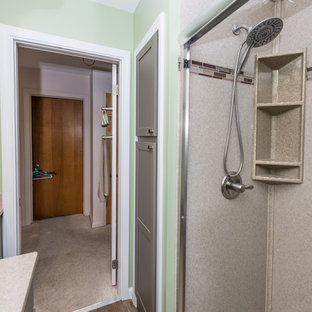 Small transitional 3/4 laminate floor and brown floor bathroom photo in Chicago with recessed-panel cabinets, gray cabinets, multicolored walls, an integrated sink and onyx countertops