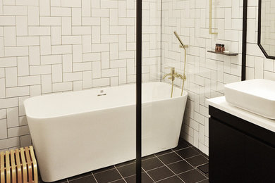 Example of a mid-sized eclectic white tile and ceramic tile ceramic tile bathroom design in Other with black cabinets, a one-piece toilet, white walls, a vessel sink, marble countertops, white countertops and raised-panel cabinets