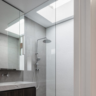 Photo of a large contemporary bathroom in Sydney with an undermount sink, granite benchtops, an open shower, a double vanity, dark wood cabinets, flat-panel cabinets, an alcove shower, gray tile, grey floor, grey benchtops and a floating vanity.