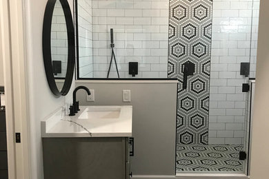 Inspiration for a large transitional master white tile and ceramic tile vinyl floor and brown floor double shower remodel in Baltimore with shaker cabinets, gray cabinets, a one-piece toilet, gray walls, an undermount sink, quartz countertops, a hinged shower door and white countertops