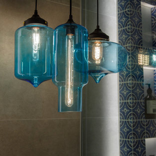 This is an example of a small mediterranean family bathroom in Hong Kong with medium wood cabinets, a walk-in shower, a one-piece toilet, blue tiles, grey walls and wooden worktops.