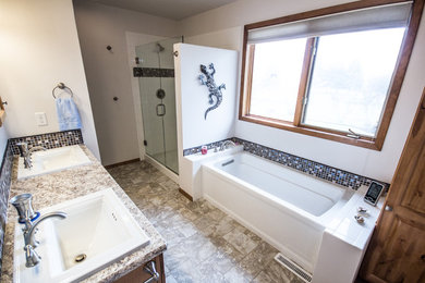Example of a large master multicolored tile and ceramic tile linoleum floor bathroom design in Other with raised-panel cabinets, medium tone wood cabinets, a two-piece toilet, white walls and a drop-in sink