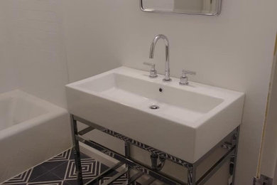 Example of a mid-sized trendy kids' white tile and subway tile ceramic tile and black floor bathroom design in Other with open cabinets, a two-piece toilet, white walls, a pedestal sink, stainless steel countertops and white countertops