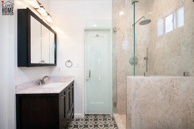 Inspiration for a large modern 3/4 beige tile and stone tile mosaic tile floor and single-sink corner shower remodel in Los Angeles with shaker cabinets, dark wood cabinets, a two-piece toilet, white walls, an undermount sink, quartz countertops, a hinged shower door, gray countertops and a freestanding vanity