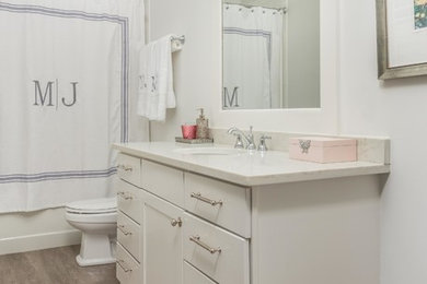 Small transitional kids' vinyl floor and gray floor bathroom photo in Charleston with flat-panel cabinets, white cabinets, a one-piece toilet, white walls, an undermount sink, quartz countertops and white countertops