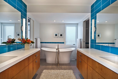 Example of a huge trendy master blue tile and glass tile dark wood floor bathroom design in Minneapolis with an undermount sink, flat-panel cabinets, light wood cabinets, quartz countertops, a one-piece toilet and white walls